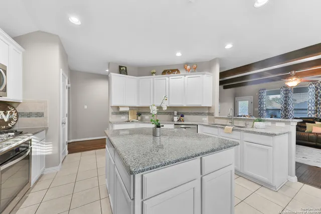 a kitchen with stainless steel appliances granite countertop a sink and stove