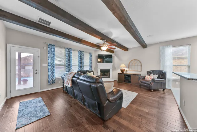 a living room with fireplace furniture and a rug