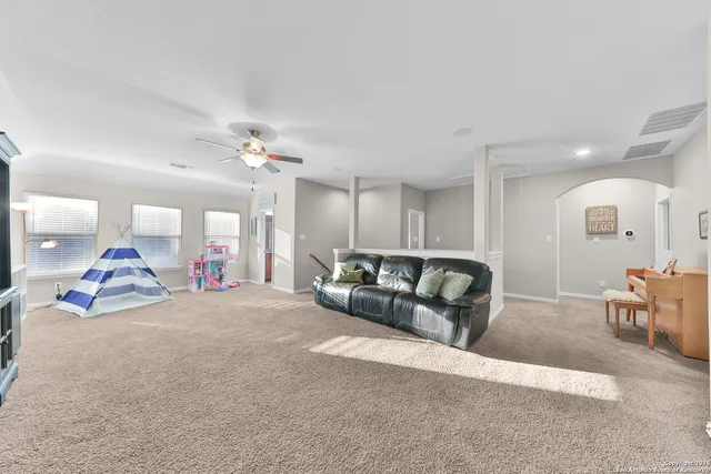 a living room with furniture and a chandelier