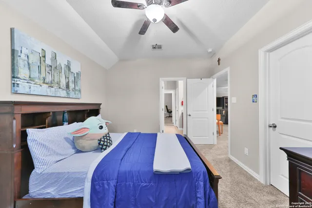 a bedroom with a bed and a chandelier