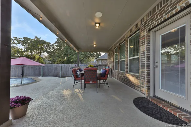 a view of a chairs and tables in the back yard of the house