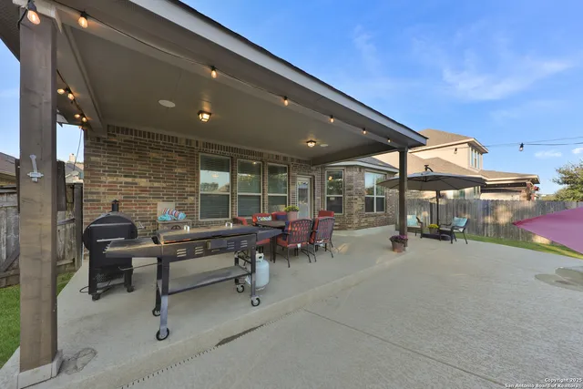 a view of a patio with table and chairs