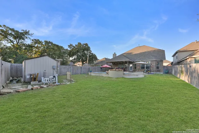 a backyard of a house with table and chairs