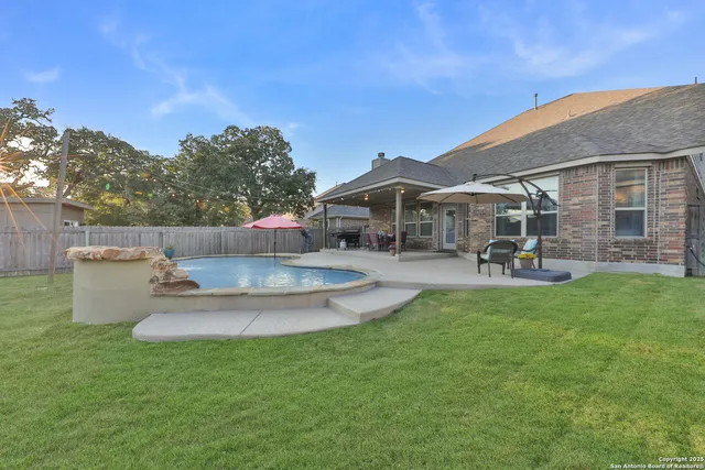 a view of a house with a backyard porch and sitting area