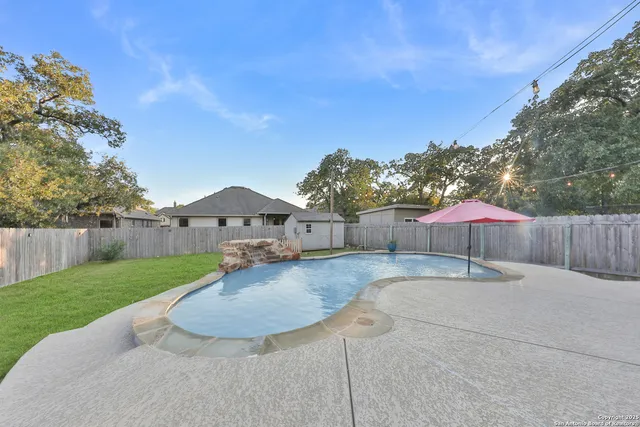 a backyard of a house with table and chairs
