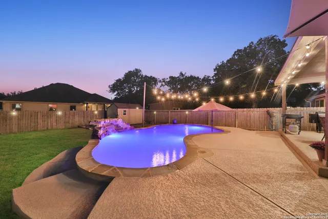 a view of a swimming pool with a yard