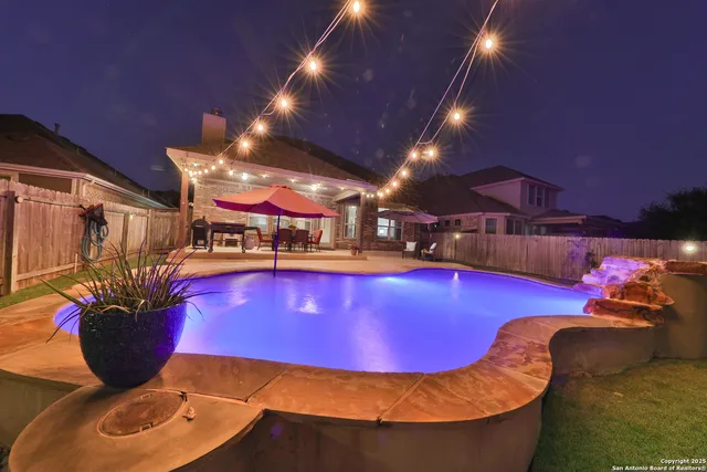 a room with furniture pool table and chairs