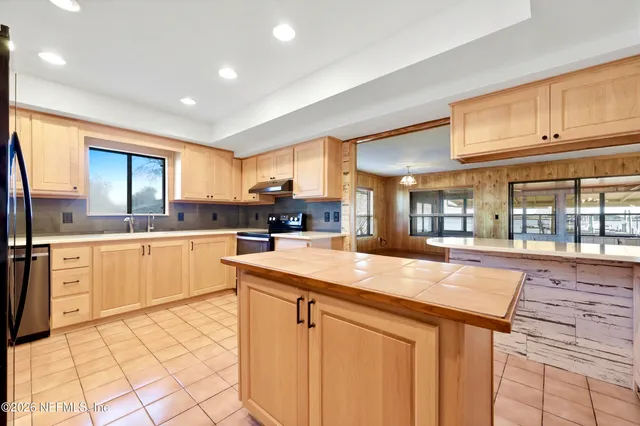 a kitchen with stainless steel appliances granite countertop a sink and cabinets