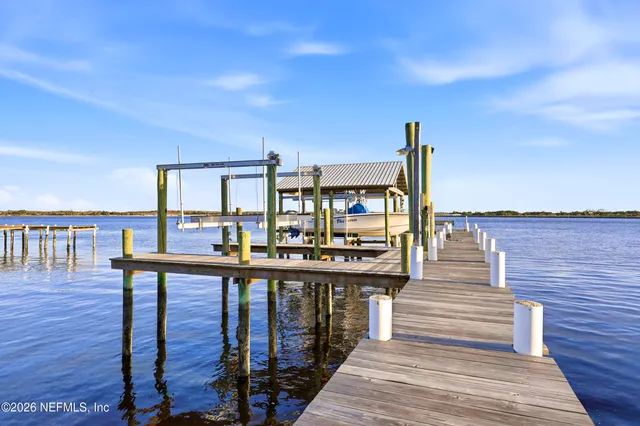 a view of a balcony with wooden floor and iron stairs