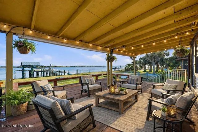 a roof deck with couches and potted plants