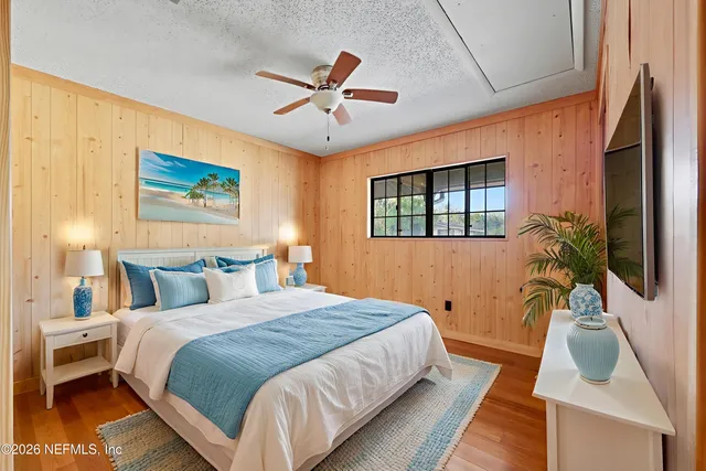 a bed room with a bed window and a flat screen tv