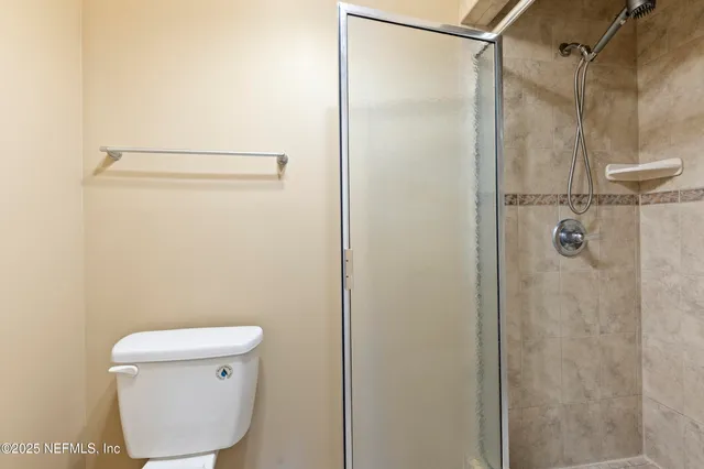 a bathroom with a toilet and a shower