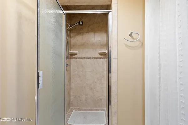 a bathroom with a glass shower door