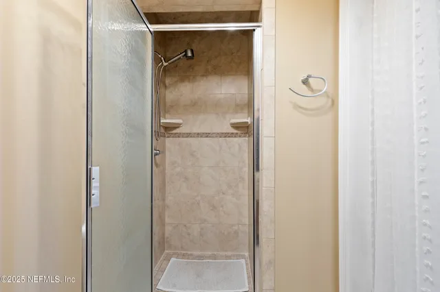 a bathroom with a glass shower door