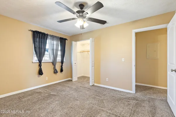 an empty room with windows and closet