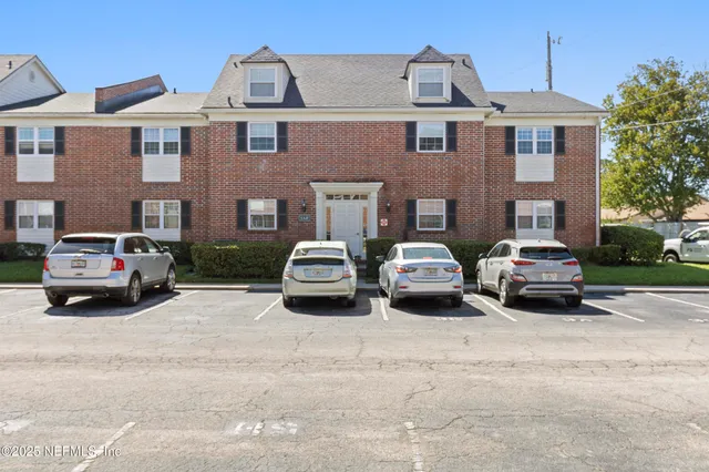 a car parked in front of a white building