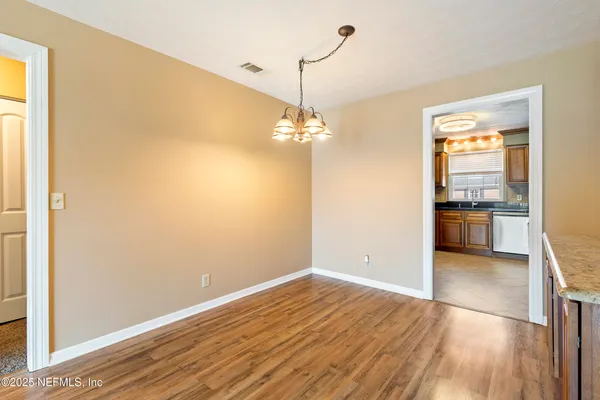 a view of a room with wooden floor and a window