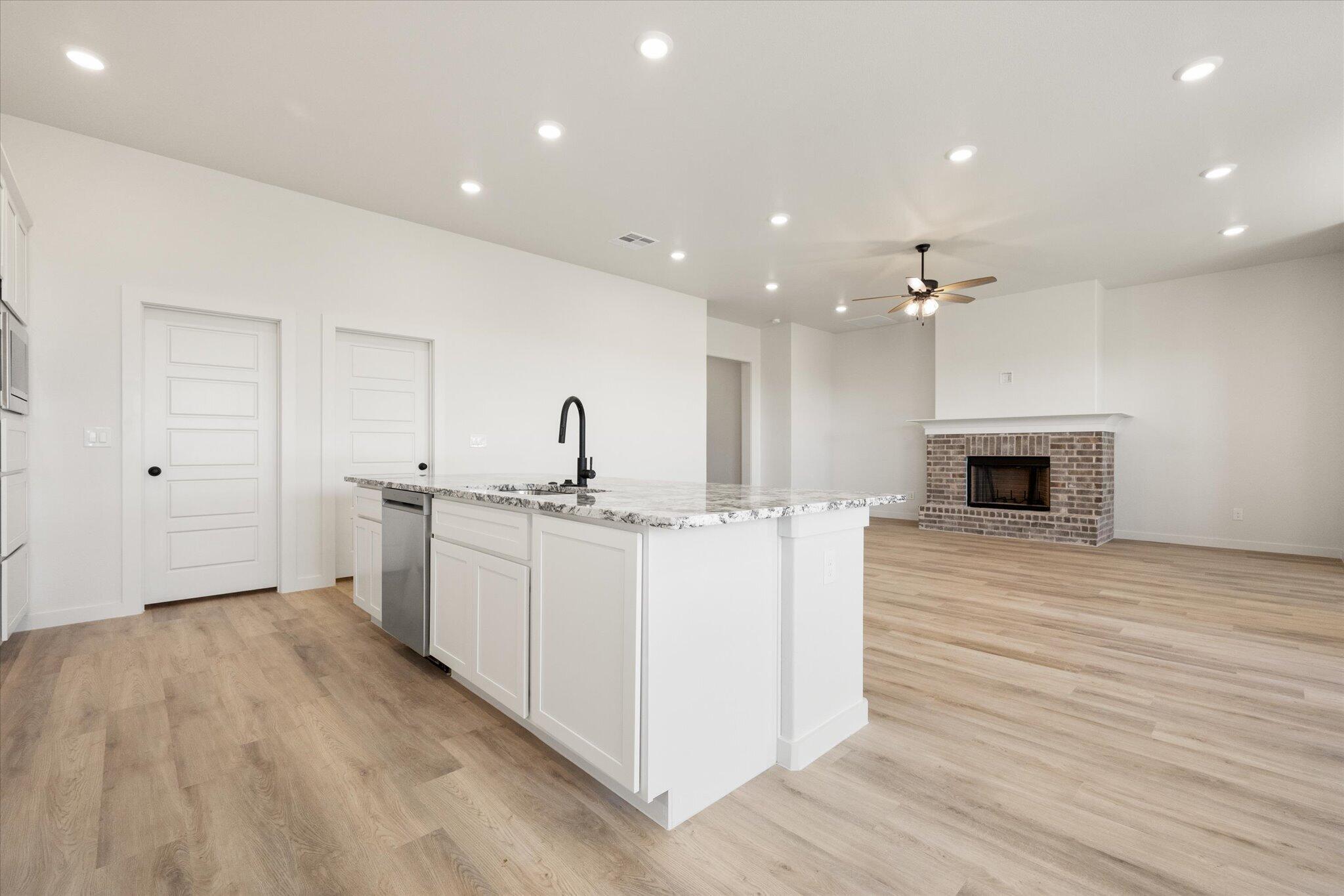 6103 121st Street Lubbock, TX 79424 - Photo 15 of 30 a large white kitchen with sink and microwave