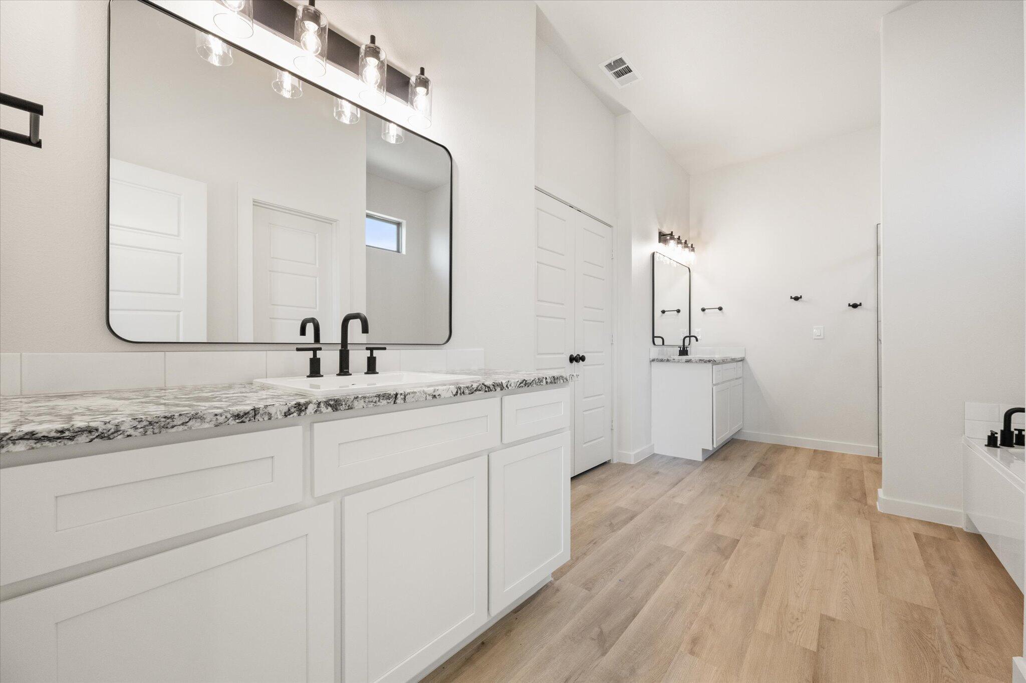 6103 121st Street Lubbock, TX 79424 - Photo 20 of 30 a bathroom with a sink and a mirror