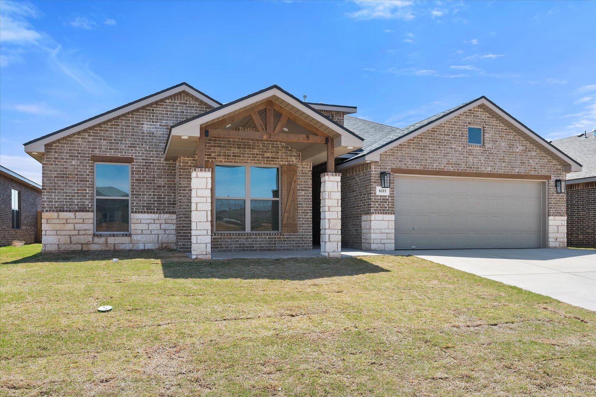 6103 121st Street Lubbock, TX 79424 - Photo 2 of 30 a view of a house with a yard and garage