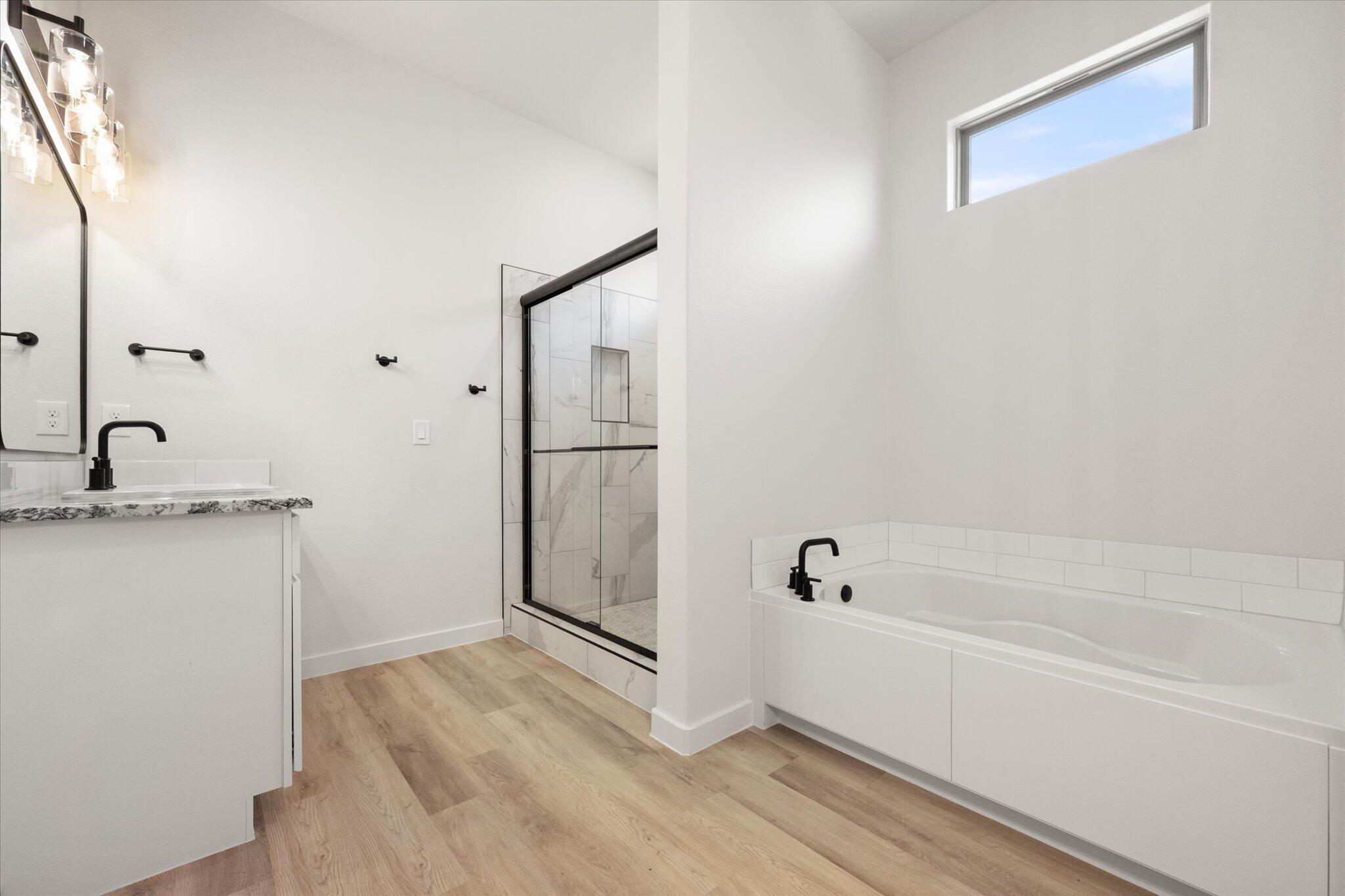 6103 121st Street Lubbock, TX 79424 - Photo 21 of 30 a bathroom with a tub and shower