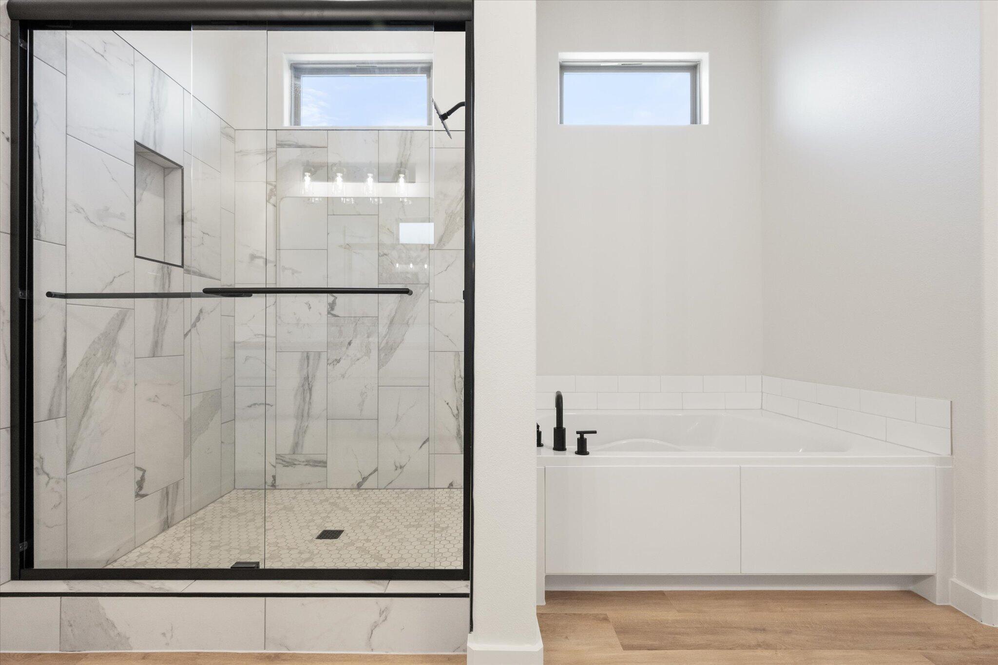 6103 121st Street Lubbock, TX 79424 - Photo 22 of 30 a bathroom with a bathtub and a shower