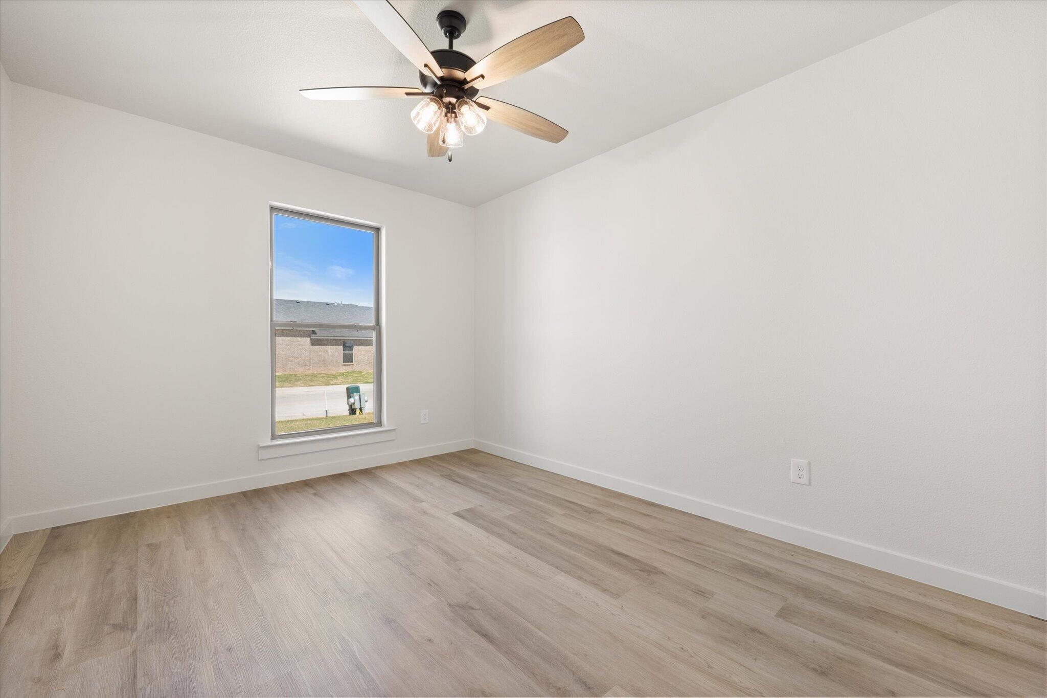 6103 121st Street Lubbock, TX 79424 - Photo 26 of 30 an empty room with a window and a fan