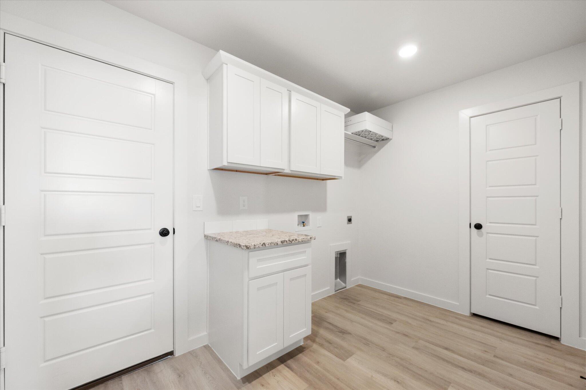 6103 121st Street Lubbock, TX 79424 - Photo 28 of 30 a view of a kitchen with dishwasher and wooden floor