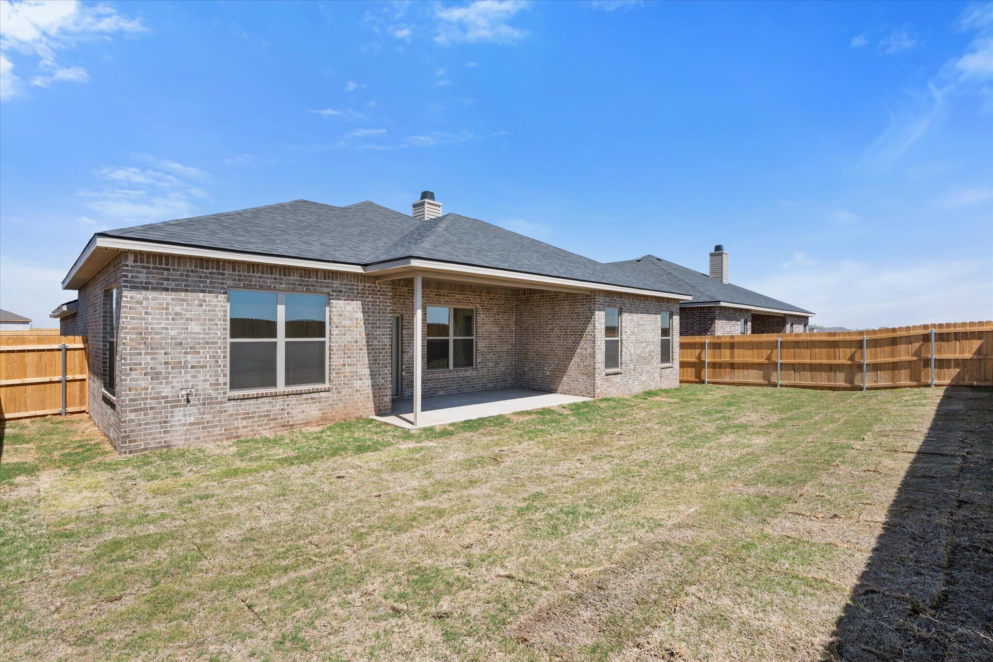 6103 121st Street Lubbock, TX 79424 - Photo 30 of 30 a front view of a house with a garden and yard