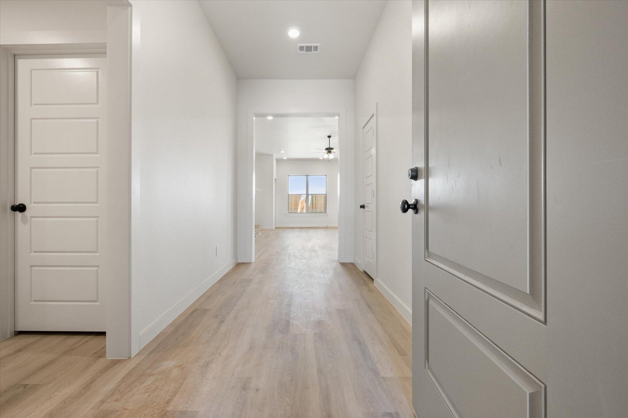 6103 121st Street Lubbock, TX 79424 - Photo 3 of 30 a view of a hallway with wooden floor
