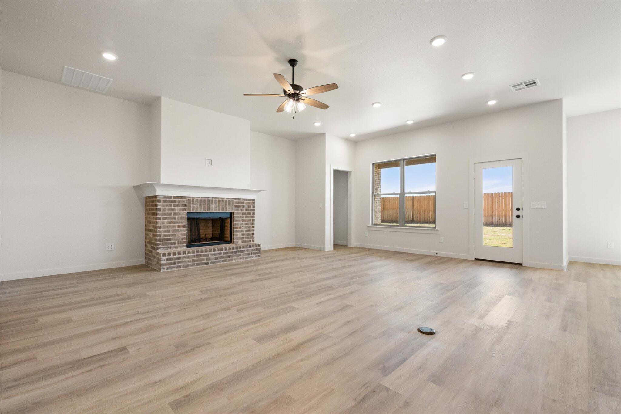 6103 121st Street Lubbock, TX 79424 - Photo 8 of 30 an empty room with windows and fireplace