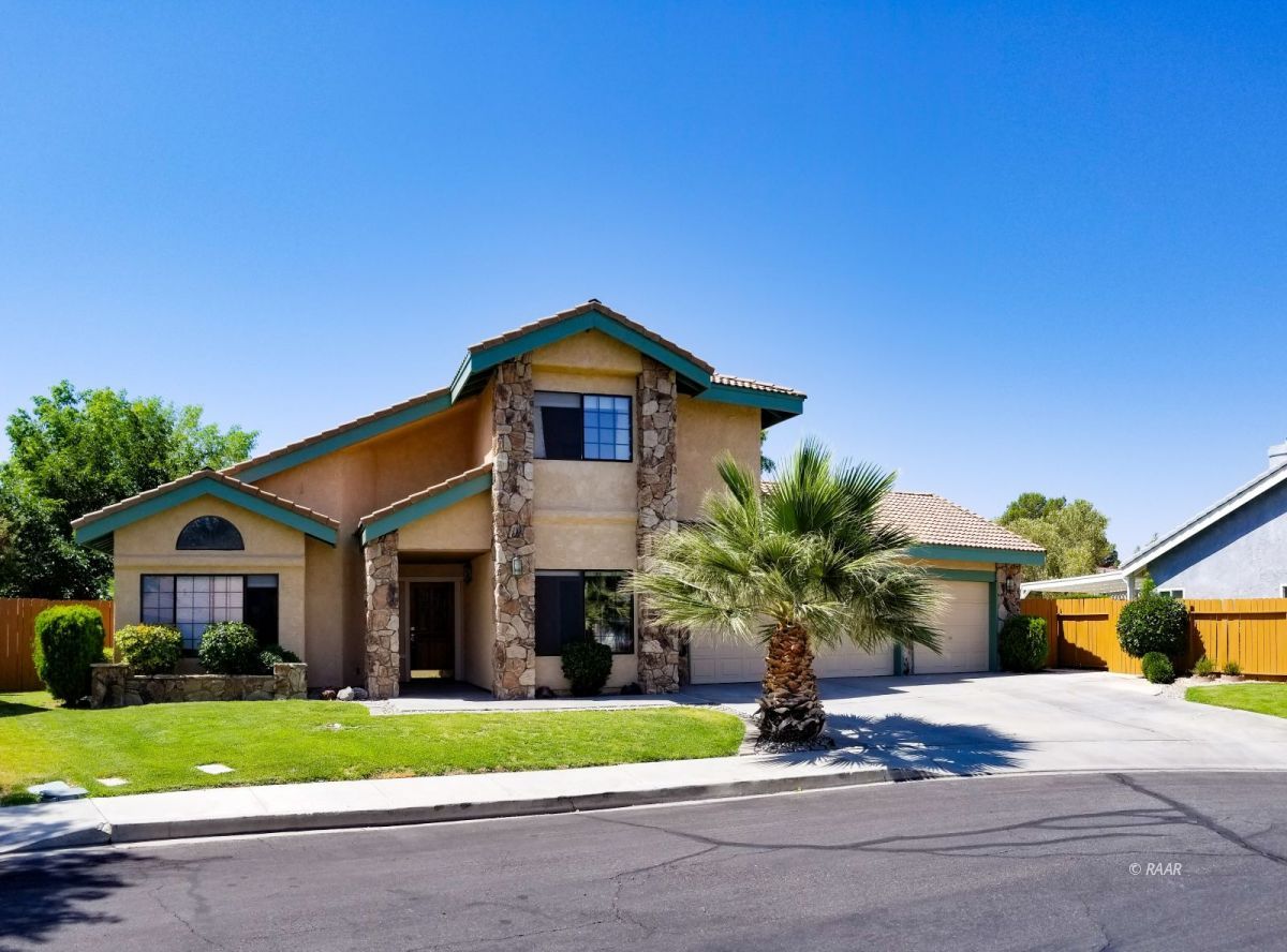 327 West Pilgrim Court Ridgecrest, CA 93555 - Photo 1 of 1 a front view of a house with a yard and garage