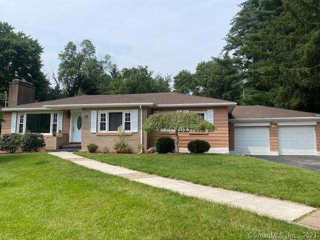 a view of a house with a yard and deck