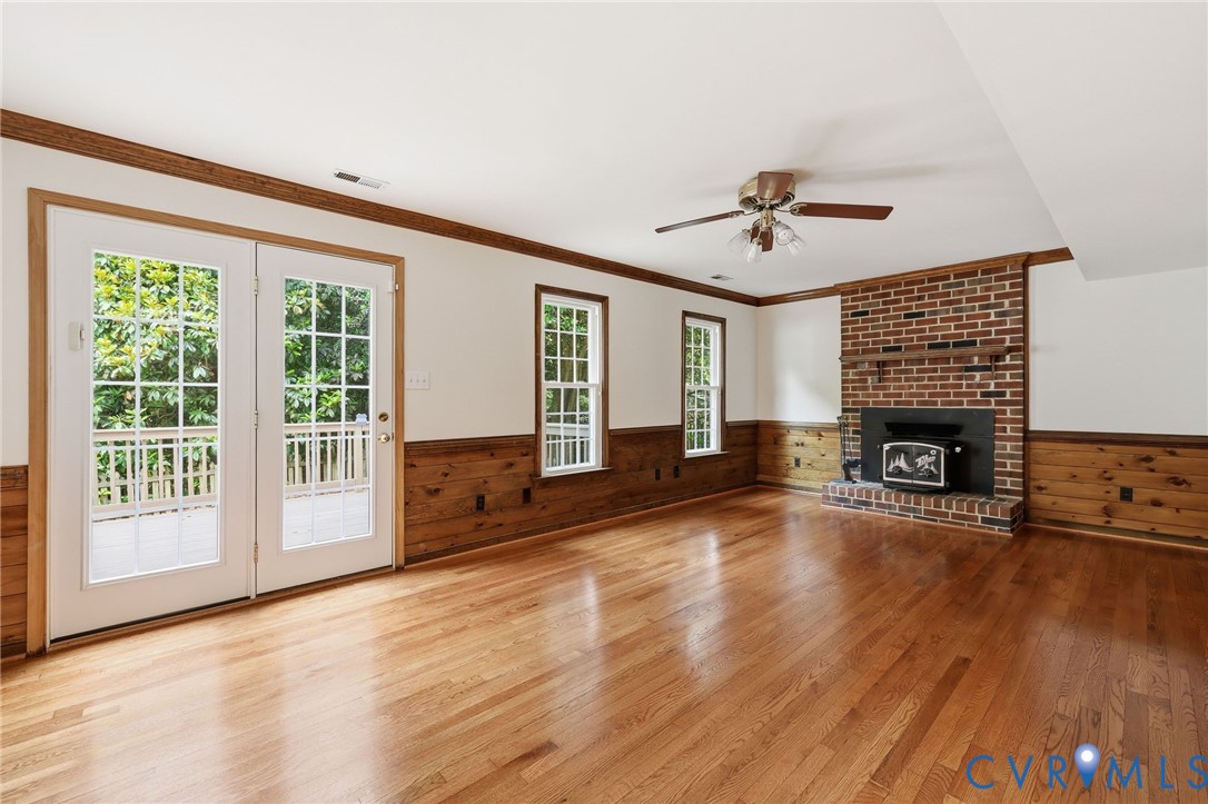 12111 Auger Lane Midlothian, VA 23113 - Photo 11 of 31 a view of a livingroom with furniture a fireplace and wooden floor