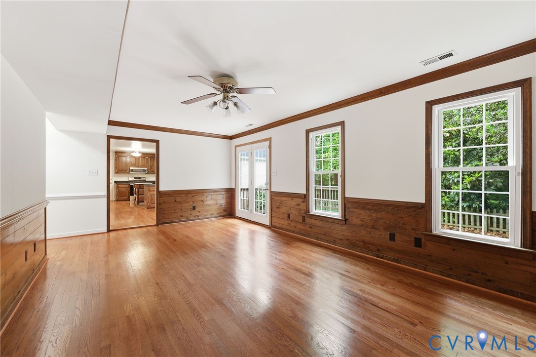 12111 Auger Lane Midlothian, VA 23113 - Photo 12 of 31 a view of an empty room with wooden floor and a window