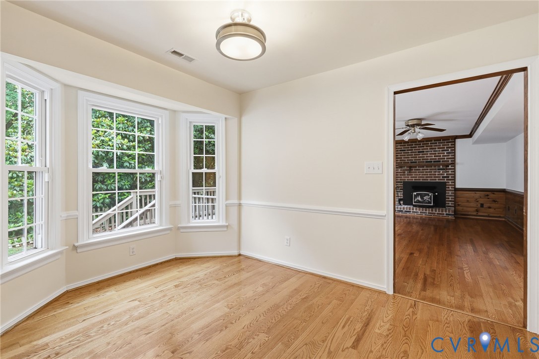 12111 Auger Lane Midlothian, VA 23113 - Photo 13 of 31 a view of an empty room with a window and wooden floor