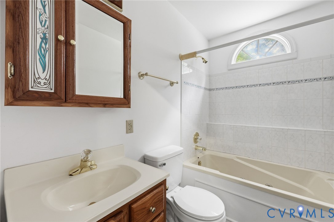 12111 Auger Lane Midlothian, VA 23113 - Photo 29 of 31 a bathroom with a sink a toilet and shower