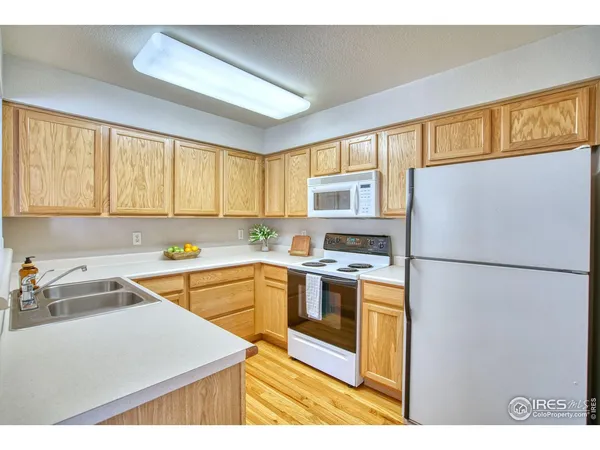 a kitchen with a refrigerator sink and cabinets