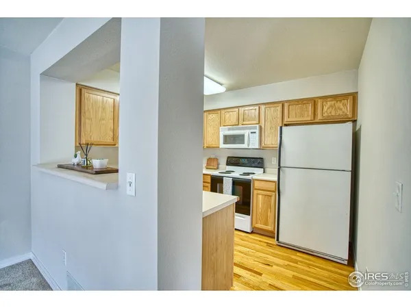 a kitchen with stainless steel appliances granite countertop a refrigerator and a stove
