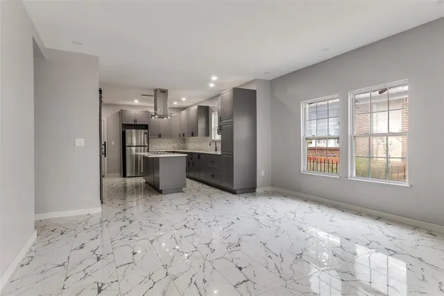 a open kitchen with stainless steel appliances kitchen island granite countertop a refrigerator sink and cabinets