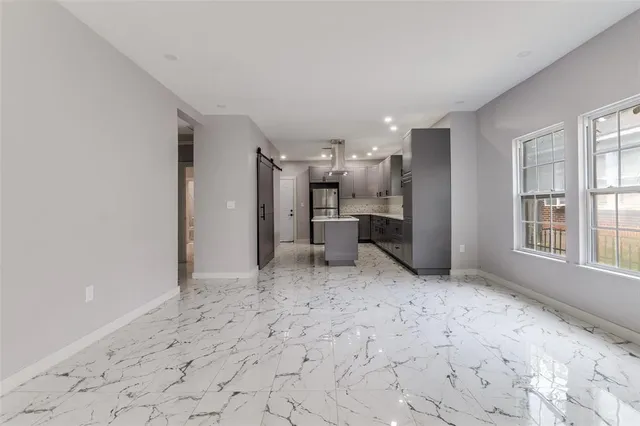 a view of a refrigerator in kitchen and windows