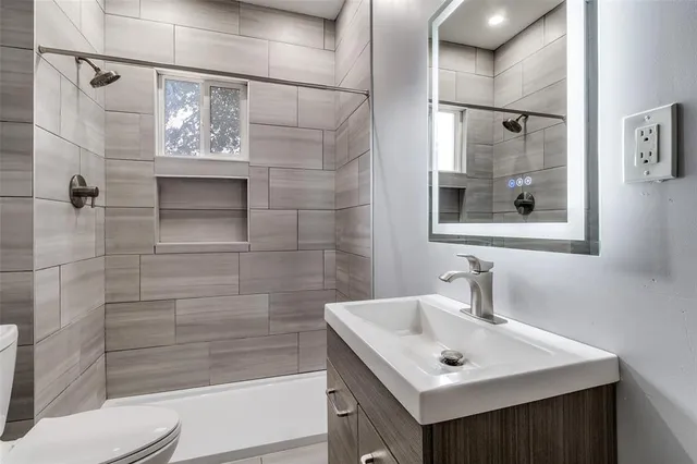 a bathroom with a sink toilet and shower