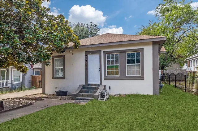 a backyard of a house with table and chairs