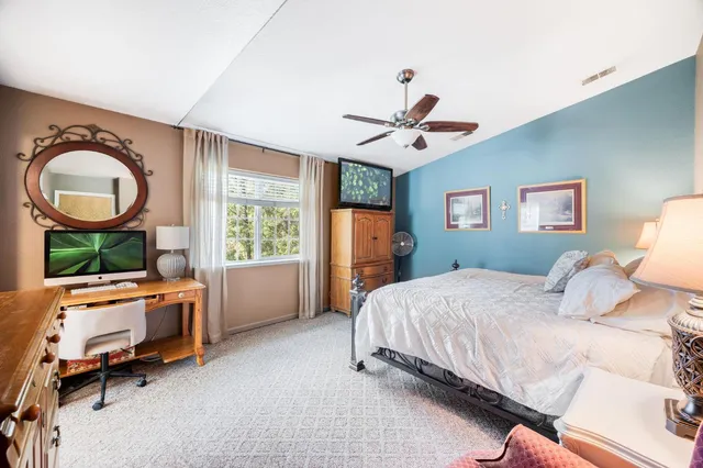 a bedroom with a large bed and a couch