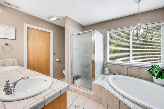 a bedroom with a bed chair and window