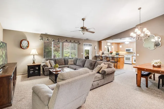 a bedroom with a large bed and wooden floor