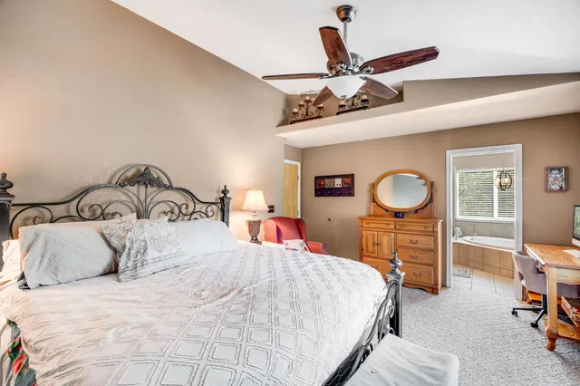 a bathroom with a granite countertop toilet sink and mirror
