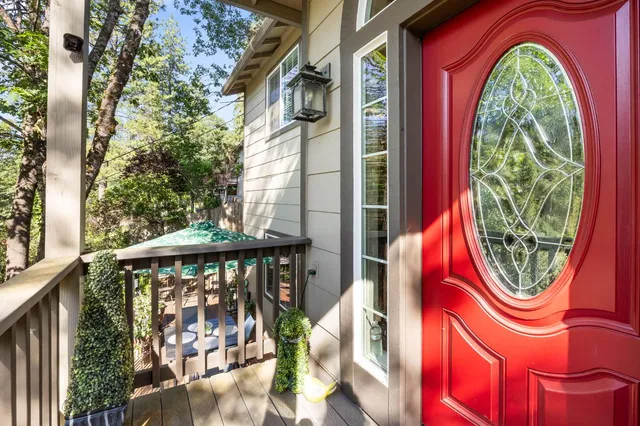 a living room with furniture a chandelier and a large window