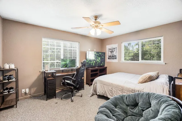 a view of a house with backyard and sitting area