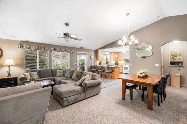 a view of a dining room with furniture and chandelier